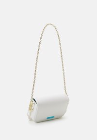 Vit rektangulär handväska med guldkedja och liten blå logotyp på framsidan, visad mot en enfärgad vit bakgrund.