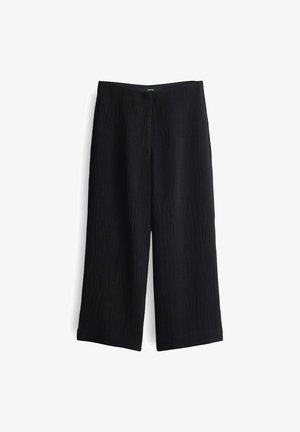 Schwarze weit geschnittene Hose aus strukturiertem Stoff mit hoher Taille und klaren Beinschnitten, die ein minimalistisches Design aufweist.