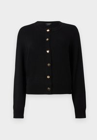 Svart långärmad cardigan med gulddekorativa knappar som har klöver-, spade-, hjärt-, blom- och palmträdssymboler, ribbade ärmslut och fåll.