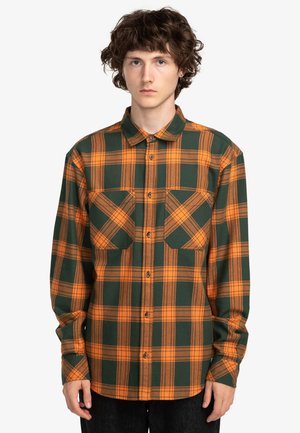 Groene en oranje geruite blouse in een knoopsluiting stijl, met twee borstzakken, lange mouwen en een kraag. Geweven stof.