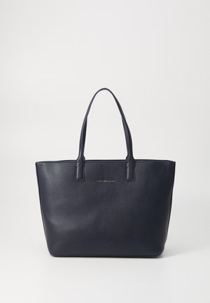 Navy leather tote bag with two sturdy handles, rectangular shape, pebbled texture, and subtle metallic logo on the front.