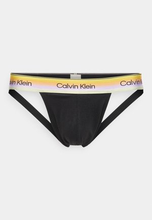 Shorty jockstrap noir pour hommes avec une ceinture à dégradé jaune-rose arborant le logo Calvin Klein en texte noir.