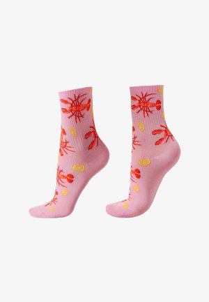 Pink socks with red lobster and yellow lemon slice patterns shown on angled foot forms against white background.