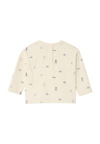 Cream-colored long-sleeve shirt featuring a print of penguins, igloos, and trees in gray. Back closure with buttons at the neck.