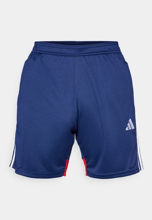 Tummansininen urheiluhousut, joissa on valkoisia ja punaisia yksityiskohtia, joustava vyötärö ja Adidas-logo alaosassa. Sileä kankaan pinta.