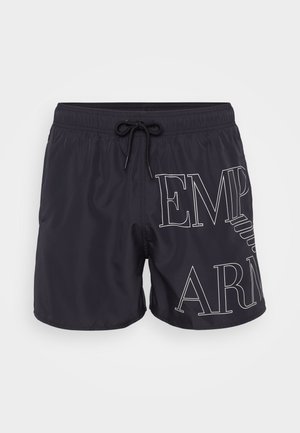 Pantaloni da bagno neri con vita regolabile, caratterizzati da scritte bianche che formano le parole "EMP" e "ARM" in un carattere audace e moderno.