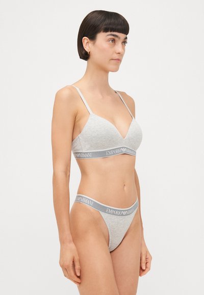 Hallhallane puuvillane rinnahoidja õhukeste rihmade ja V-kaelusega, millele on lisatud sobivad tanga-aluspesu elastse vööga, millel on kiri "Emporio Armani."
