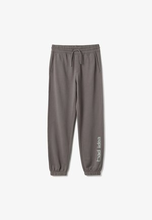 Pantaloni da jogging grigi con vita e polsini elasticizzati, tasche laterali, coulisse e scritta "bad idea" sulla parte inferiore della gamba destra.