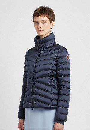 Navy puffer jacket with a high collar, featuring quilted panels and zippered pockets. Fabric has a smooth, shiny texture.