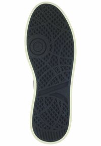 Black rubber shoe sole with textured diamond pattern, white edge, circular logo detail, and ridged tread for enhanced grip.