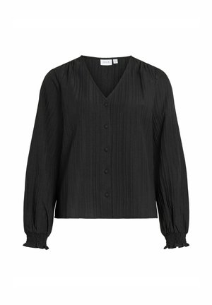 Must must pluus V-kaelusega, pikkade varrukatega ja nööpidega kinnitusega. Omab vertikaalseid voltse ja kogutud mansette, valmistatud tekstuurse kangaga.