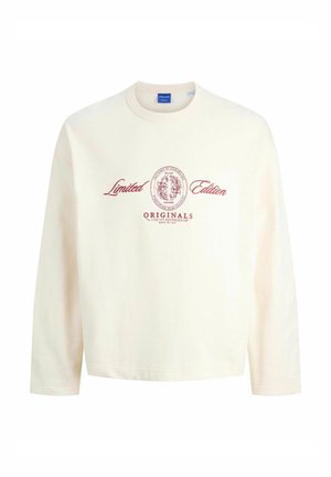 Sweatshirt crème à coupe décontractée, avec des manches longues, un col rond et un texte imprimé rouge qui dit "Édition Limitée" et "ORIGINALS."