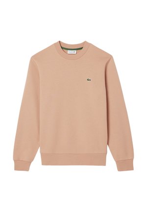 Felpa rosa chiaro realizzata in morbido tessuto, con scollo rotondo e maniche lunghe. Logo Lacoste ricamato in verde sul petto.