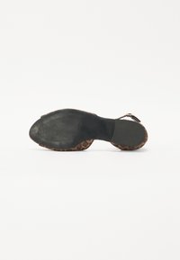 Leopard print heeled sandal with a black rubber sole, adjustable ankle strap, and textured fabric upper. Bottom features a patterned design.