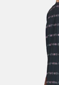 Black dress featuring a floral pattern with pink roses and green vines, made from soft fabric, designed with a relaxed fit and short sleeves.