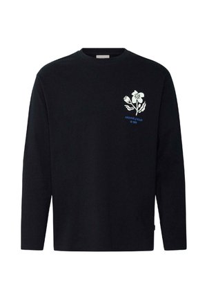 Chemise noire à manches longues avec un motif floral blanc et le texte bleu « ARCHIVE of SOLID © 1999 » sur le haut gauche de la poitrine.