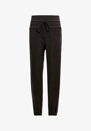 Zwarte joggerbroeken van zacht materiaal, met een elastische tailleband met een trekkoord en taps toelopende boorden bij de enkels.
