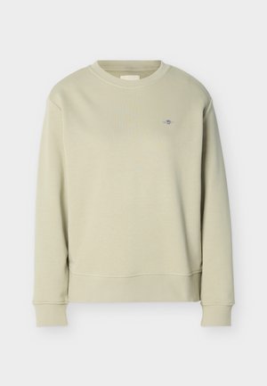 Hellbeige Sweatshirt mit Rundhalsausschnitt, langen Ärmeln und kleinem gesticktem Logo auf der linken Brust, dargestellt vor weißem Hintergrund.