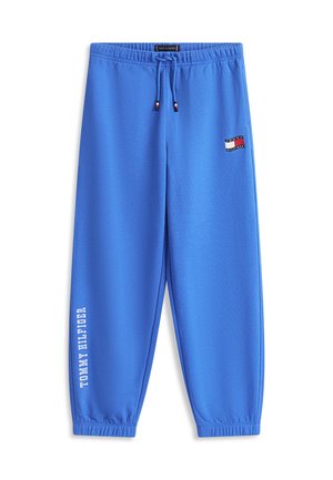 Modre Tommy Hilfiger trenirke z elastičnim pasom in manšetami, z vrvico za zategovanje, značko z logotipom na bokih in navpično natisnjenim imenom blagovne znamke na levi nogi.