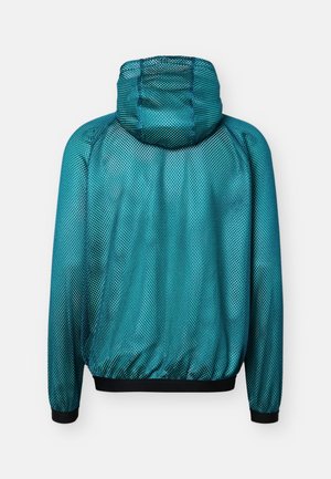 Veste à capuche bleu sarcelle à manches longues avec une texture en maille et des poignets et une ceinture élastiques noirs, vue de dos.