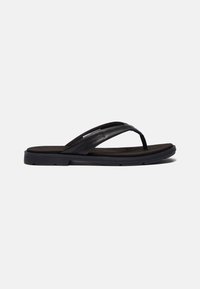 Black flip-flop made of leather with a textured black insole. Features two narrow straps and a flexible rubber sole.
