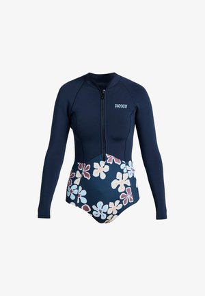 Marineblauw wetsuit met lange mouwen, rits aan de voorkant, bloemenpatroon op de onderste helft, en "ROXY" logo op de borst.