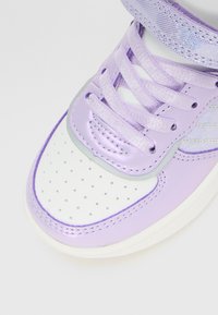 Purple and white sneaker with laces, perforated toe box, and glittery iridescent strap detail on a white background.