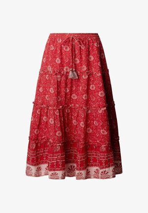 Jupe midi rouge à volants avec motifs floraux et géométriques blancs, taille élastique et lien frontal avec pompons.