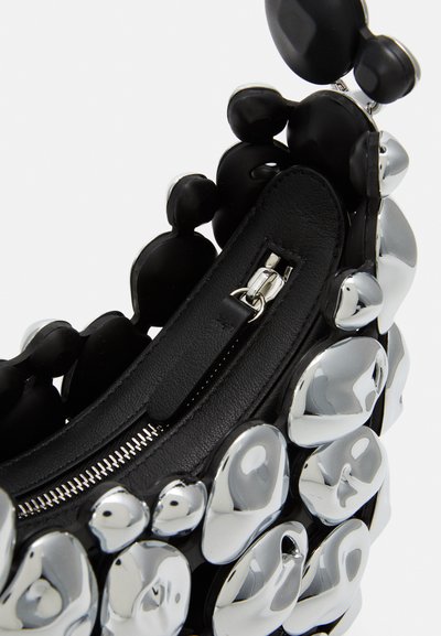 Black handbag with a textured finish, featuring metallic silver accents and rounded shapes. Includes a zippered compartment.