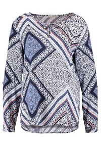 Blouse à manches longues en bleu marine et blanc avec motifs fleuris et géométriques en patchwork. Dotée d'un col rond et d'une coupe décontractée. Tissu léger.