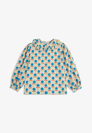 Langærmet skjorte med en flæset krave, præget af et blåt og orange cirkulært mønster på en lysegul baggrund. Knaplukning foran.