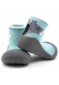 Zapatos estilo calcetín de color azul con suela de goma gris, que presentan una superficie texturizada y un upper con patrón. El diseño incluye un gráfico divertido.