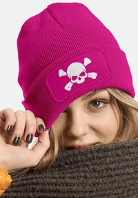 Fuchsia knitted beanie with a white skull and crossbones graphic on a patch. The texture is ribbed and the fit is snug.