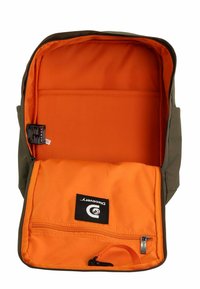 Green backpack with orange interior. Features a spacious compartment, a zippered pocket, and a label with the brand "Discovery."