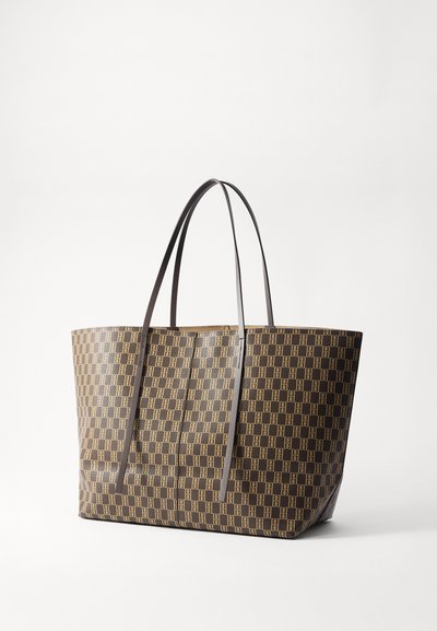Brown tote bag with a geometric pattern, made of textured material, featuring two long brown handles for carrying.