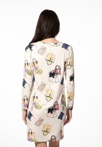 Langärmliges Kleid in hellem Creme mit einem bunten Handtaschenprint. Weicher Stoff, lockere Passform und Rundhalsausschnitt.