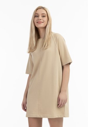 Beige katoenen jurk met korte mouwen en een ontspannen pasvorm. Beschikt over een ronde halslijn en subtiele naaddetails. Glad textuur.