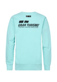 Sudadera verde menta con mangas largas y escote redondo. El texto en la parte posterior dice "GRAN TURISMO® EL VERDADERO SIMULADOR DE CONDUCCIÓN" en color negro.