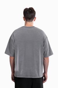 Gray oversized t-shirt with short sleeves, made of soft cotton. Features a round neckline and a smooth, slightly textured finish.