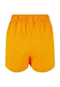 Täppet oranžid puuvillased lühikesed püksid elastse vöökohtaga, millel on lihtne disain ja sile tekstuur. Alamserv on ümar, taskuteta.