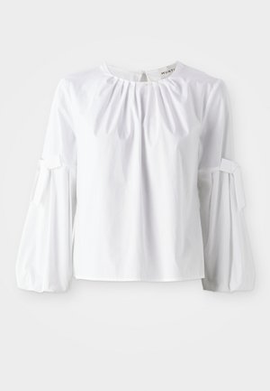 Biała bluzka z długim rękawem, wykonana z bawełny, z okrągłym dekoltem, subtelnymi plisami i zawiązywanymi mankietami, które nadają jej wyrafinowany kształt i fakturę.