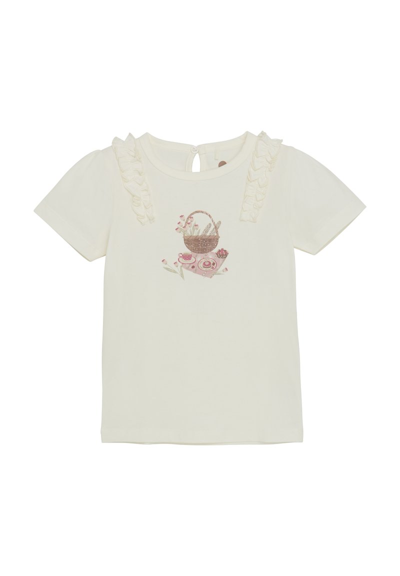 Ljus krämfärgad t-shirt med korta puffärmar, volangdetaljer på axlarna och en tryckt korgdesign med blommor på framsidan.