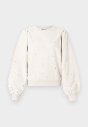 Sweatshirt beige clair avec des manches bouffantes, des poignets et un ourlet côtelés. Présente des motifs de cœurs en relief sur le devant, fabriqué en matériau doux.