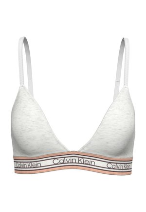 Bralette blanc Calvin Klein avec fines bretelles réglables et bande élastique à logo dans des tons beige et blanc.
