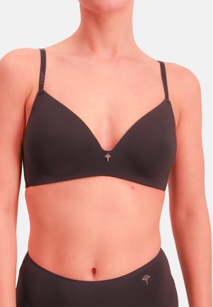 Musta saumaton rintaliivi, jossa syvä V-kaula-aukko, ohuet säädettävät olkaimet ja pieni metallinen logotunnus keskellä.