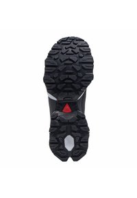 Black rubber sole with deep tread patterns, featuring a red triangular accent near the heel and a white component in the center.