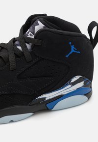 Black suede sneaker with blue accents, featuring a patterned collar, textured overlays, and a glossy, reflective midsole.