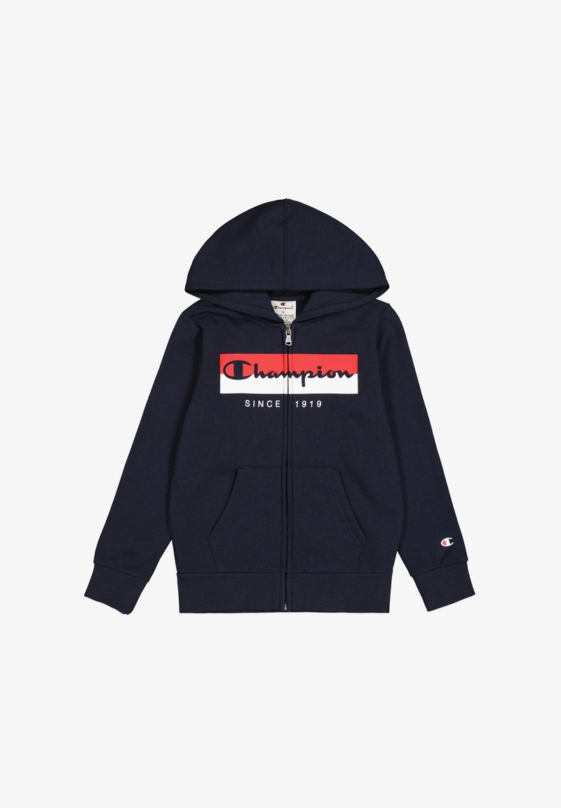 Sweat à fermeture éclair bleu marine en coton, avec un graphique sur le devant affichant le texte "Champion" en rouge et blanc. Comprend une capuche et des poches latérales.