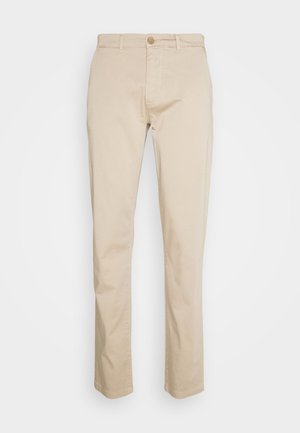 Beige bomullschinos med rak ben-design, knäppning fram, hällor för bälte och en slät textur. Passar för avslappnad och semi-formell klädsel.