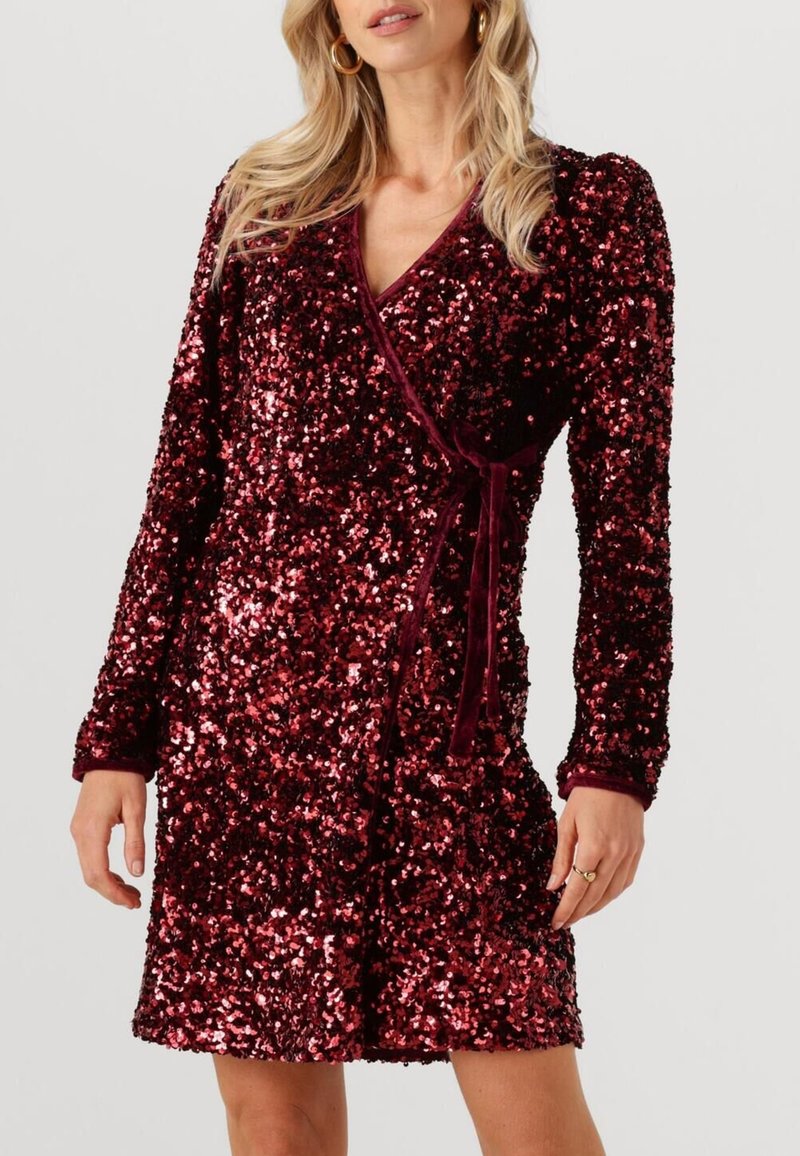 Robe bordeaux à sequins avec manches longues, col en V et taille à nouer. Caractérisée par une texture scintillante et un design portefeuille.